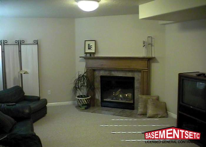 Cozy living room featuring a fireplace, seating area, and decorative plants.