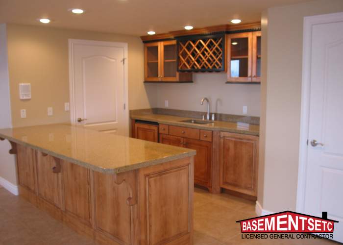 Stylish basement kitchenette with wooden cabinets and granite countertop