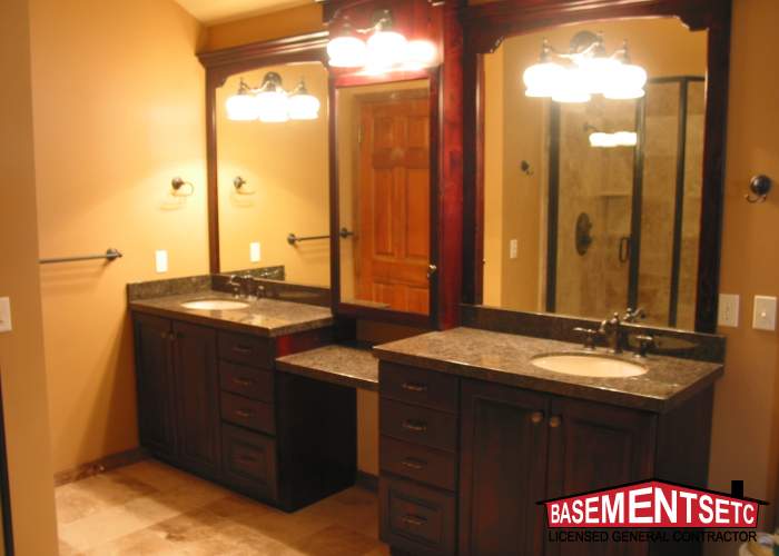 Modern bathroom with dual sinks, dark wood cabinets, and large mirrors.