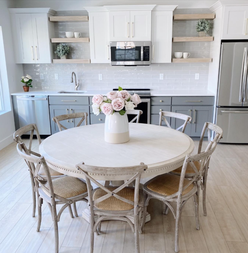 Round dining table with floral centerpiece in a modern kitchen