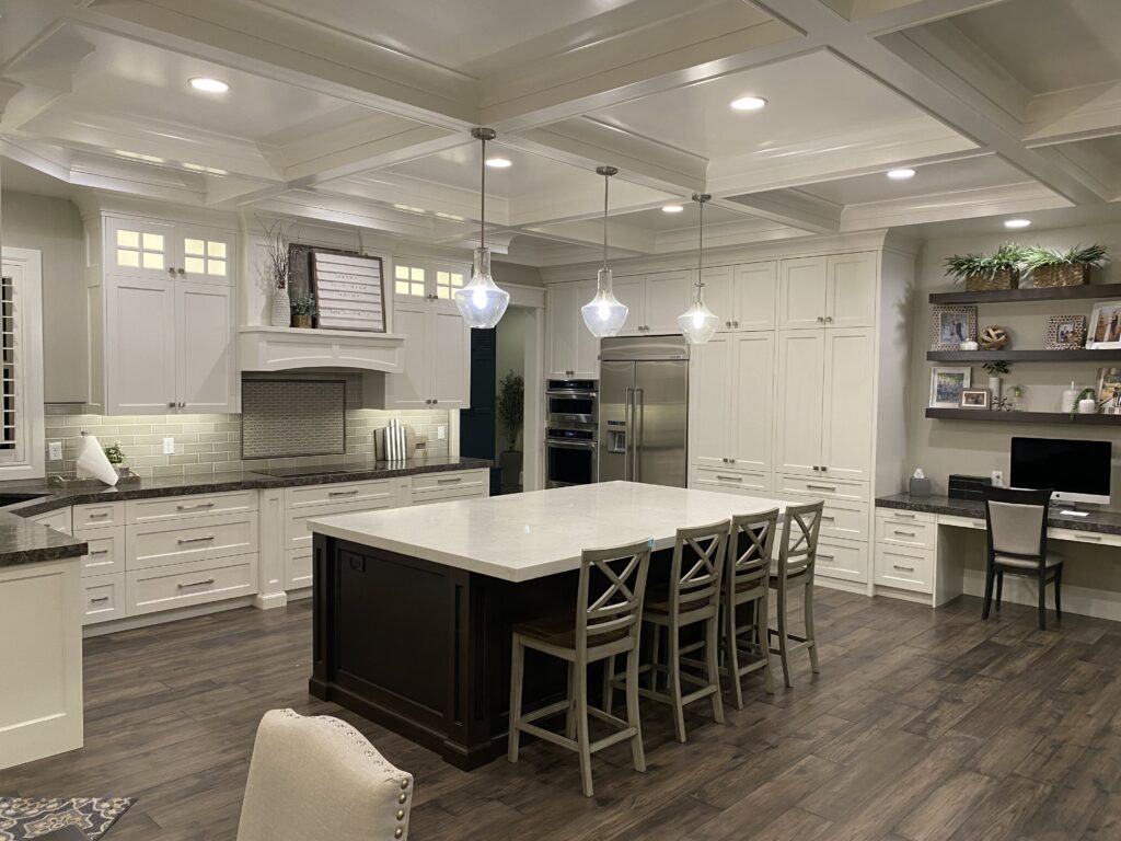 Modern kitchen with white cabinets, a large island, and pendant lights.